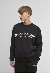 Černá mikina vyrobená z bavlněné směsi, se vystřiženým výstřihem a nařasenými manžetami. Text na přední straně zní "bruno banani NOT FOR EVERYBODY."