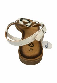 Sandalia de cuero blanca con correa ajustable, plantilla acolchada marrón y suela de goma. Acentuada con una etiqueta que muestra la talla 39.