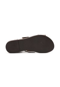 Brown leather shoe with a textured rubber sole, featuring a smooth upper design and a smooth, slightly rounded toe.