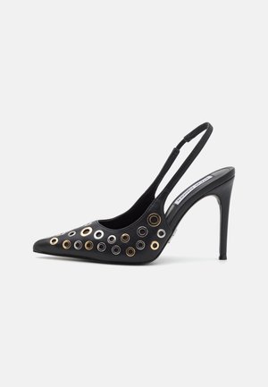 Black leather slingback pump featuring a pointed toe, stiletto heel, and decorative metallic grommets in silver, gold, and bronze.