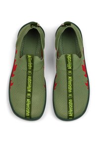 Green slip-on shoes with red leaf patterns, breathable mesh upper, textured surface, and green logo strap across the front.
