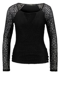 Haut en dentelle noir à manches longues avec des motifs géométriques et paisley, des manches semi-transparentes et une silhouette ajustée.
