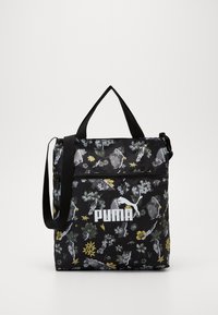 Borsa di stoffa nera con motivi floreali in grigio, giallo e verde. Include un manico superiore, una tracolla e un logo bianco ben visibile.