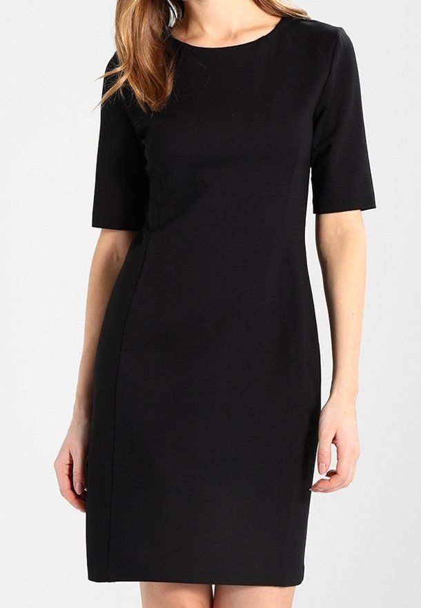 Musta polvipituinen mekko lyhyillä hihoilla, vartalonmyötäinen malli, pyöreä pääntiellä ja sileä pinta, sopii erilaisiin tilaisuuksiin.