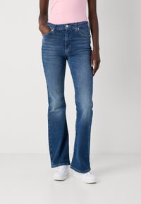 Ullsydde blå jeans laget av denim, med middels høy livhøyde, fem lommer og en lys vask med subtile slitasjedetaljer.