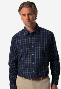 Camicia a quadri blu navy con dettagli blu chiaro, colletto button-down, maniche lunghe e una tasca sul petto. Tessuto dalla superficie liscia.