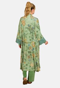 Green floral-patterned robe with wide sleeves and vertical striped cuffs, tied at the waist. Pair of green pants viewable from the back.