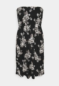 Svart strapless klänning med smockad bodice, prydd med ett blommönster i vitt och beige. Flödar mjukt vid knäna med en mjuk textur.
