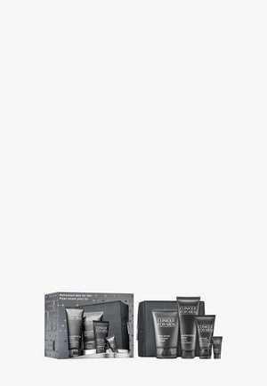 Herren-Pflegeset in schwarzer Verpackung, beinhaltet Tuben und eine Tasche. Enthält graue Akzente und Etiketten, mit Produkten zur Reinigung und Befeuchtung.