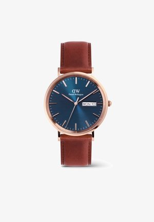 Hnedý kožený remienok s hodinkami, modrý texturovaný ciferník, púzdro z ružového zlata, strieborné hodinové indexy a displej dátumu na pondelok, 10.