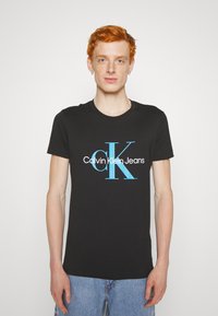 Calvin Klein Jeans SEASONAL MONOLOGO TEE - Apdrukāts T-krekls - black