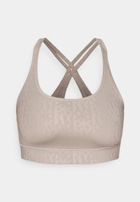 Sports bra in light beige with a subtle logo pattern. Features a cross-back design and smooth texture, suitable for athletic wear.