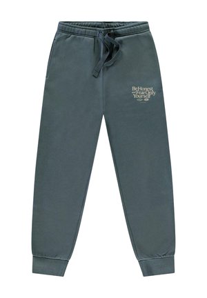 Dark green sweatpants with elastic cuffs and waistband, drawstring, side pockets, and small white text on the upper thigh reading "Be Honest and Fear Only Yourself."