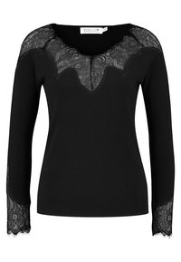 Pull noir à manches longues, avec des accents en dentelle aux épaules et aux poignets, et un décolleté en V profond. Texture lisse avec une silhouette cintrée.