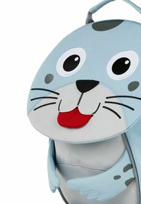 Blue fabric backpack shaped like a seal, featuring large eyes, a smiling mouth, and flipper details. Durable material with a textured finish.