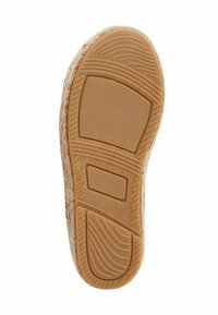 Rubber shoe sole with a textured pattern, featuring a tan color and "MADE IN SPAIN" imprint. Smooth edges and defined grip lines visible.
