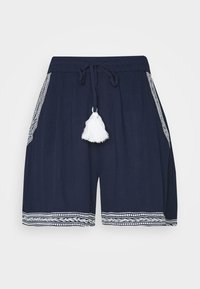 Shorts bleu marine avec une taille élastique, un cordon de serrage et un pompon blanc. Présentent une broderie blanche décorative sur les poches et l'ourlet.