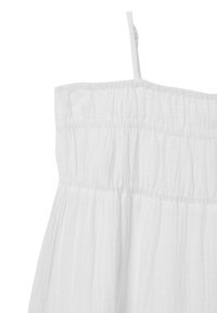 Camisola bianca in cotone con arricciature elastiche nella parte superiore, spalline sottili e un tessuto morbido e strutturato. Nessun motivo o dettaglio visibile.