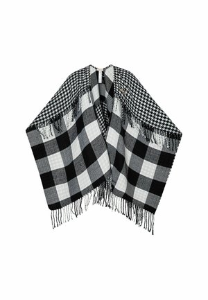 Poncho a scacchi bianco e nero con diversi motivi a quadri, dettagli in frangia lungo i bordi e una texture morbida.
