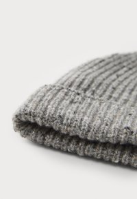 Gray knit beanie featuring a ribbed texture, folded cuff, and soft wool material with subtle flecks throughout.