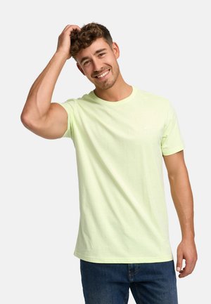 Light green cotton t-shirt with short sleeves, crew neck, subtle logo on the chest, and relaxed fit, paired with blue denim jeans.