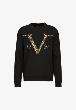 Sweat-shirt noir avec col rond, présentant un grand motif orné en jaune et gris en forme de "V" et le motif "1969" sur le devant.