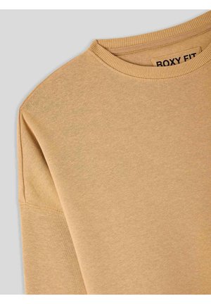 Felpa marrone chiaro con collo rotondo e vestibilità ampia. Tessuto liscio, collo ribattuto e branding minimale all'interno del colletto.