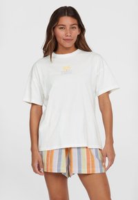White cotton t-shirt with short sleeves and a round neckline, featuring a colorful palm tree graphic. Paired with multicolored striped shorts.