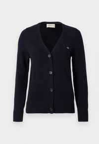 Navy blue cardigan with a V-neck, five button closure, ribbed cuffs and hem, features a small logo on the left chest. Made of knit material.