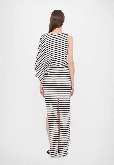 Black and white striped dress with asymmetrical shoulder design, slim fit, and side slit, made from a soft, flowing fabric.