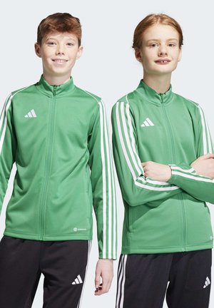 Groene zip-up jassen met witte drie-streep accenten, gemaakt van gladde stof. Beschikt over hoge kragen en een logo op de borst.