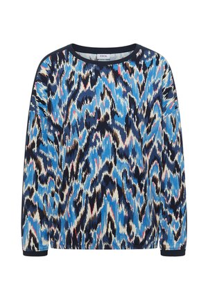 Chemise à manches longues à col rond avec un motif abstrait en zigzag bleu, noir, blanc, marron et rose, étiquetée "CECIL" à l'intérieur du col.