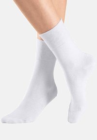 White cotton socks with a ribbed cuff, featuring a seamless design and a smooth texture. Suitable for everyday wear.