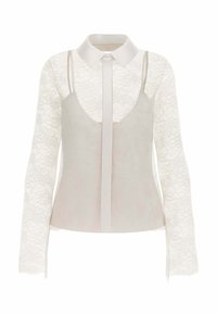 Lys grå top med krave, der har et overlay i blonde med lange ærmer. Hoveddelen har en glat tekstur og en skåret rygdesign.