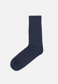 Mörkblå socka tillverkad av ett texturerat tyg. Har en ribbad kant högst upp och en slät tåsektion. Enkel, funktionell design.
