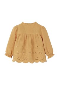 Mustard yellow long-sleeve blouse with eyelet embroidery and scalloped hem. Made from textured fabric with a gathered, loose fit.