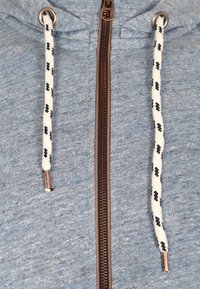 Blue heathered hoodie with a front zipper, white drawstrings with black patterns, and copper accents on the zipper. Soft fabric texture.