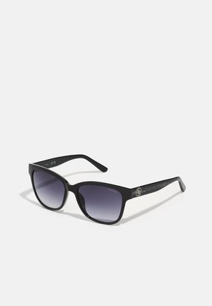 Black sunglasses with a gradient dark to light lens, rectangular shape, textured side arms, and a logo detail on the temple.