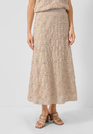 Beige midi skirt with textured floral patterns worn with matching top and metallic block-heeled sandals on white background.