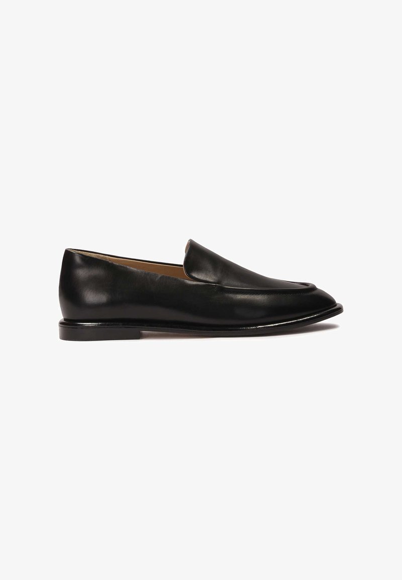 Black leather loafers with a sleek silhouette, rounded toe, and slightly raised back. Features a smooth finish and minimal hardware.