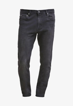 Jeans de mezclilla negros de corte slim, con diseño de cinco bolsillos, cierre de cremallera y un sutil acabado de desgaste. Textura suave con un acabado de lavado oscuro.