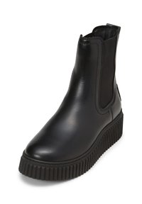 Bottine en cuir noir avec un bout arrondi, des panneaux latéraux élastiques et une semelle à plateforme nervurée pour plus de traction. Texture lisse et design épuré.