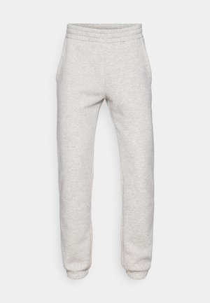 Lichtgrijze sweatpants van een zachte, gestructureerde stof. Kenmerkt zich door een elastische tailleband en taps toelopende boorden. Geen zichtbare zakken of patronen.
