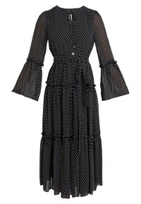 Robe midi noire à pois blancs, manches longues cloche transparentes, jupe à volants, ceinture à la taille et encolure goutte d’eau avec liens devant.