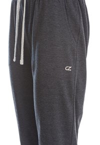 Mörkgrå joggers med elastisk midja, snörning och sidfickor. Har en liten broderad logotyp på låret. Mjuk textur.