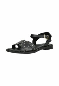 Sandale plate en cuir noir avec bride à la cheville, boucle dorée et bandes cloutées à l'avant pour un usage décontracté.