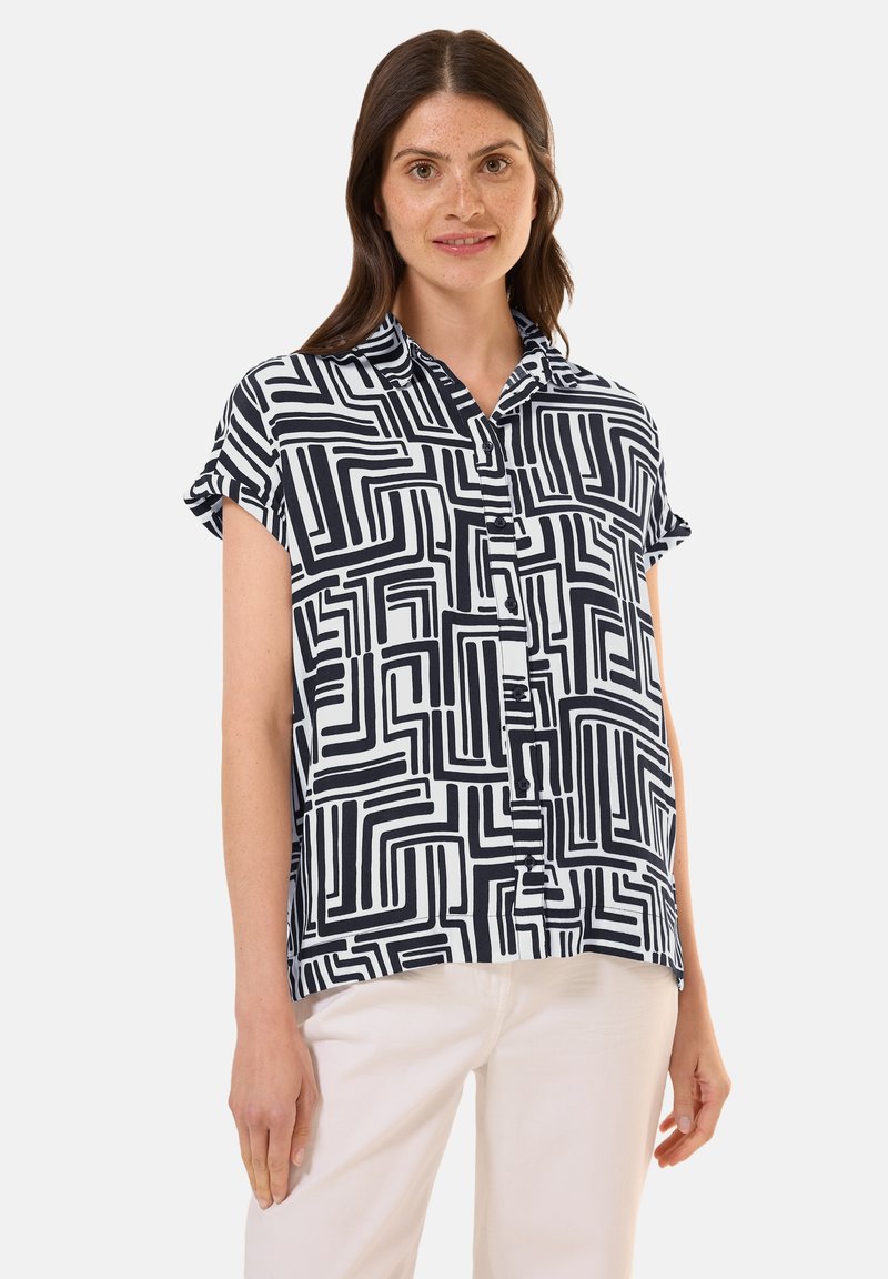 Camicia a maniche corte con bottoni in bianco e nero a motivo geometrico, caratterizzata da un colletto e una vestibilità rilassata, realizzata in tessuto leggero.