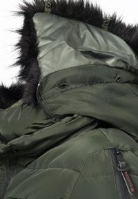Green insulated jacket with a textured black faux fur-lined hood and zippers. Features include quilted pattern and adjustable components.