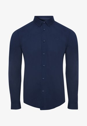 Chemise à manches longues bleu marine en tissu lisse, dotée d'un devant à boutons, d'un col pointu et d'un petit logo brodé sur la poitrine.