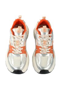 Silver sneakers with orange accents, featuring a mesh design, thick white soles, and patterned laces. Branding visible on the tongue.